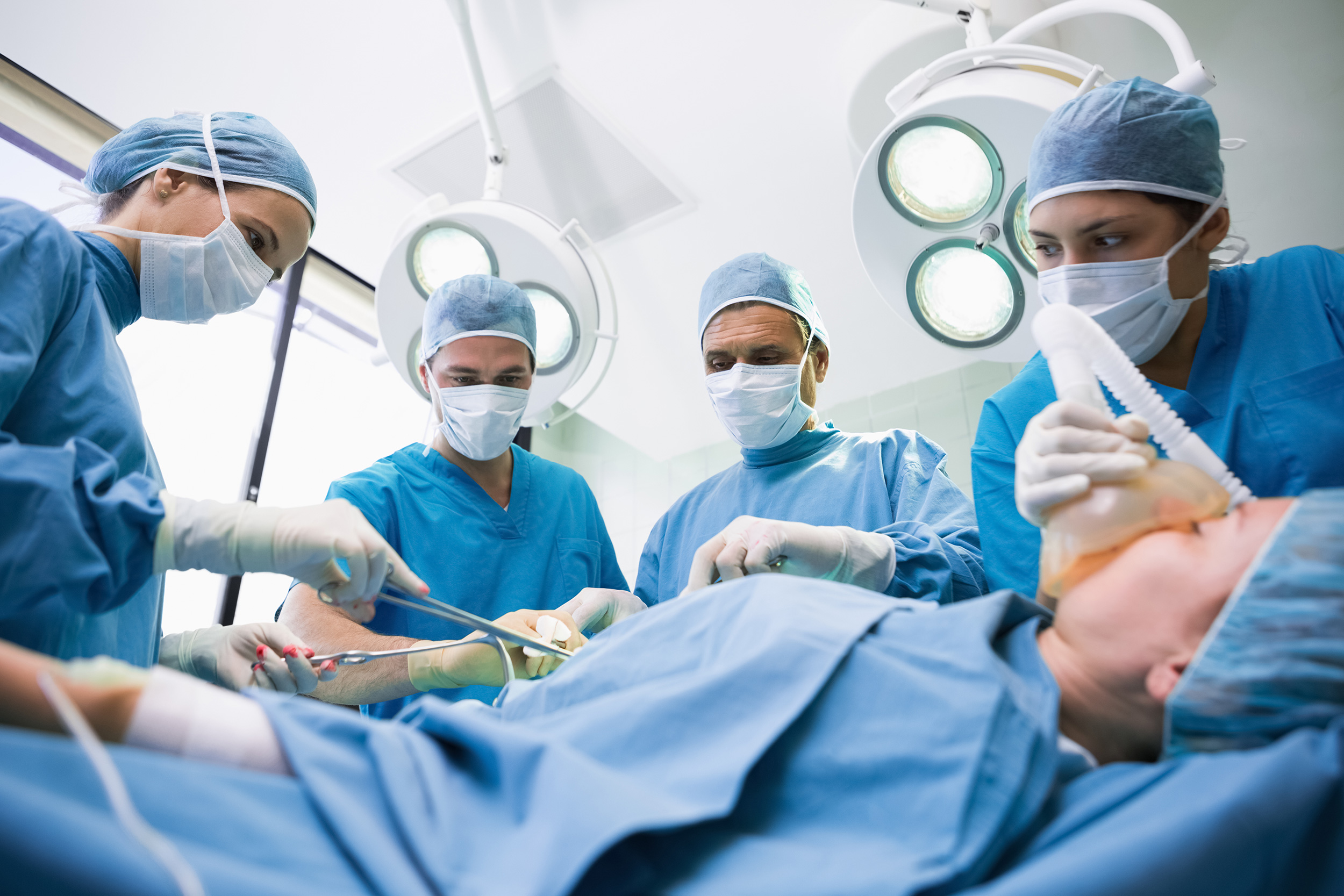 Surgeons gather around a patient at the operating table. Shaffer & Shaffer law firm handles product liability lawsuits in West Virginia.