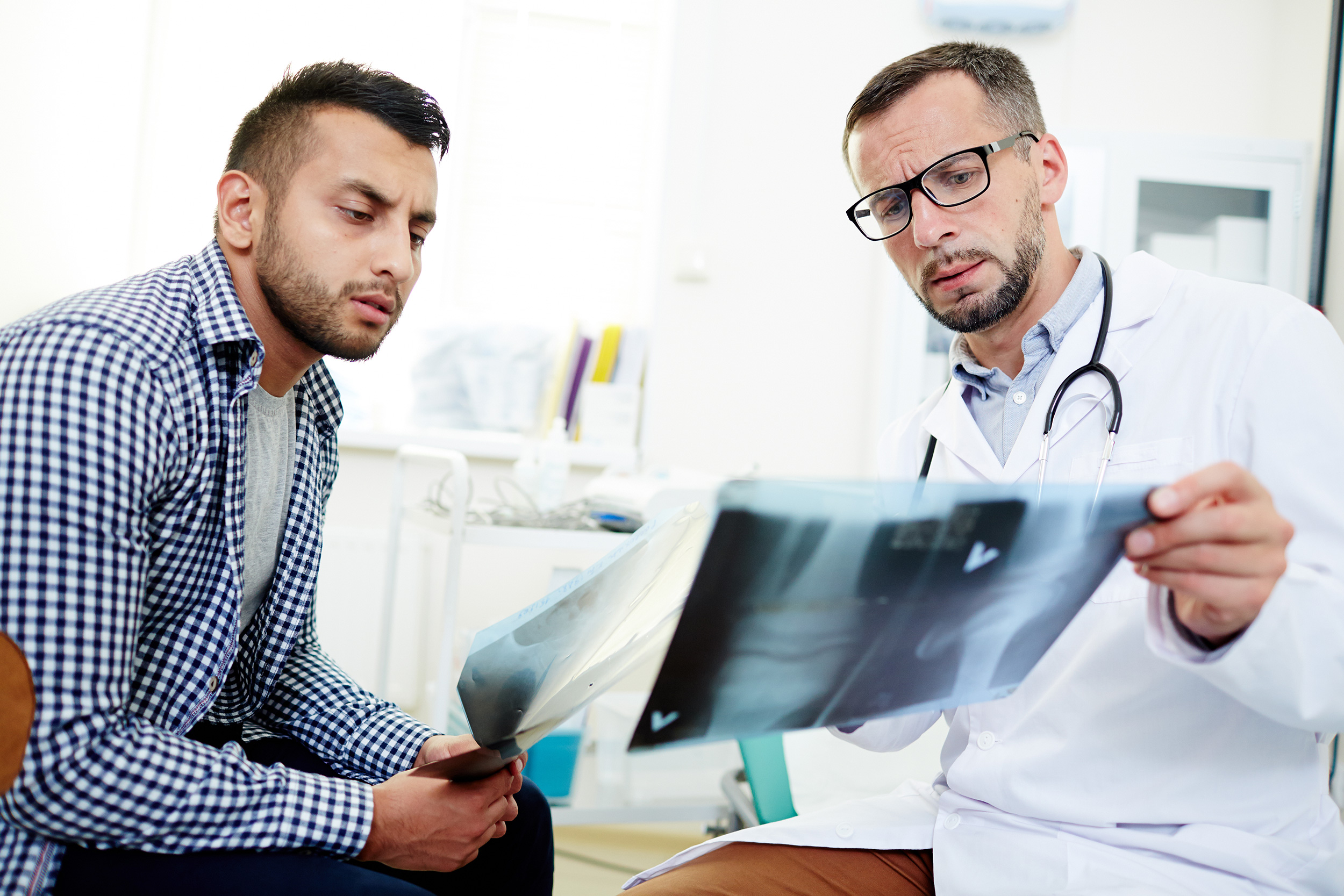 A doctor shows x-ray sheets to a man. You can claim multiple forms of compensation after a delivery vehicle accident.