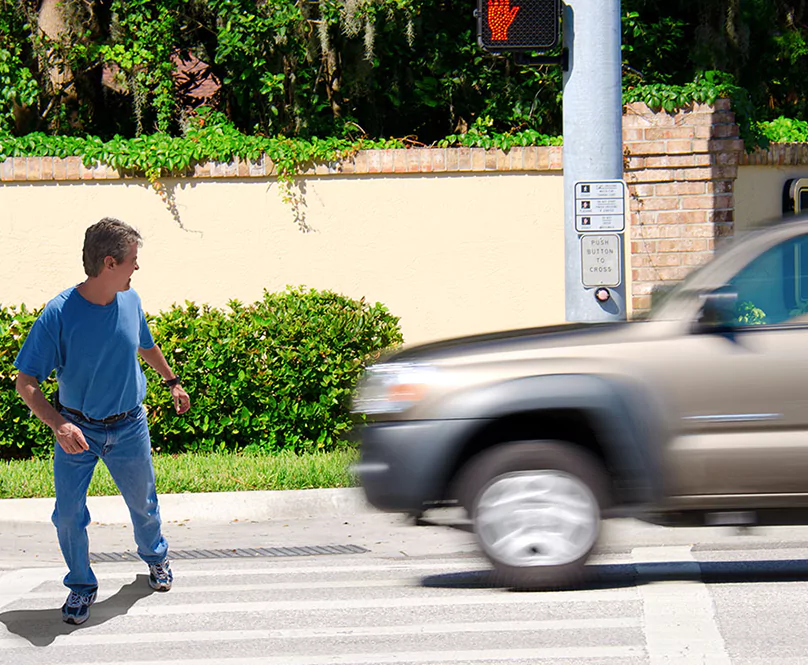 A pedestrian about to be struck by a car.