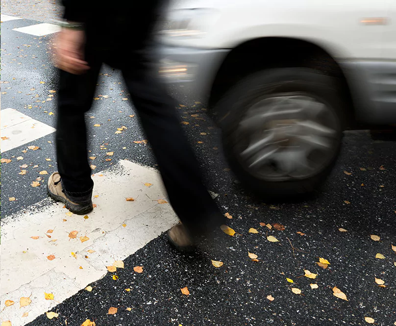 A pedestrian about to be struck by a car.
