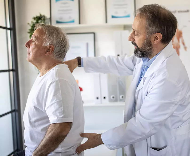 A doctor testing his patient's back pain.